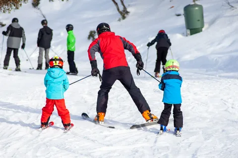 A group taking a ski lesson on a snow-covered slope.