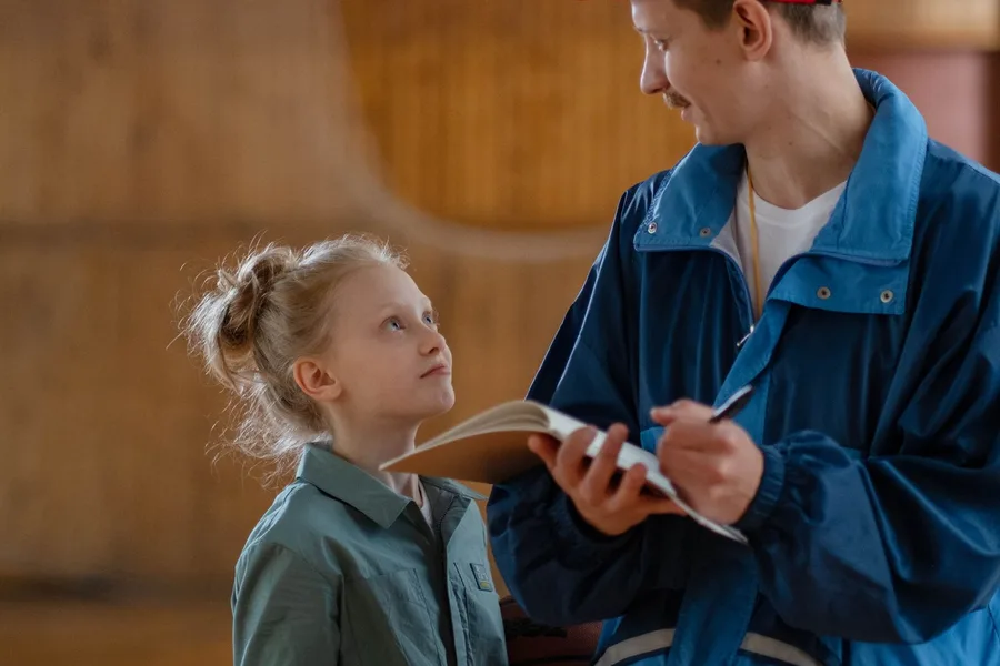 A coach talking with a young athlete.